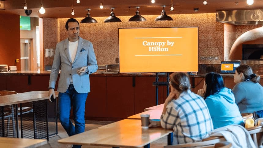 a man talking to a group of students