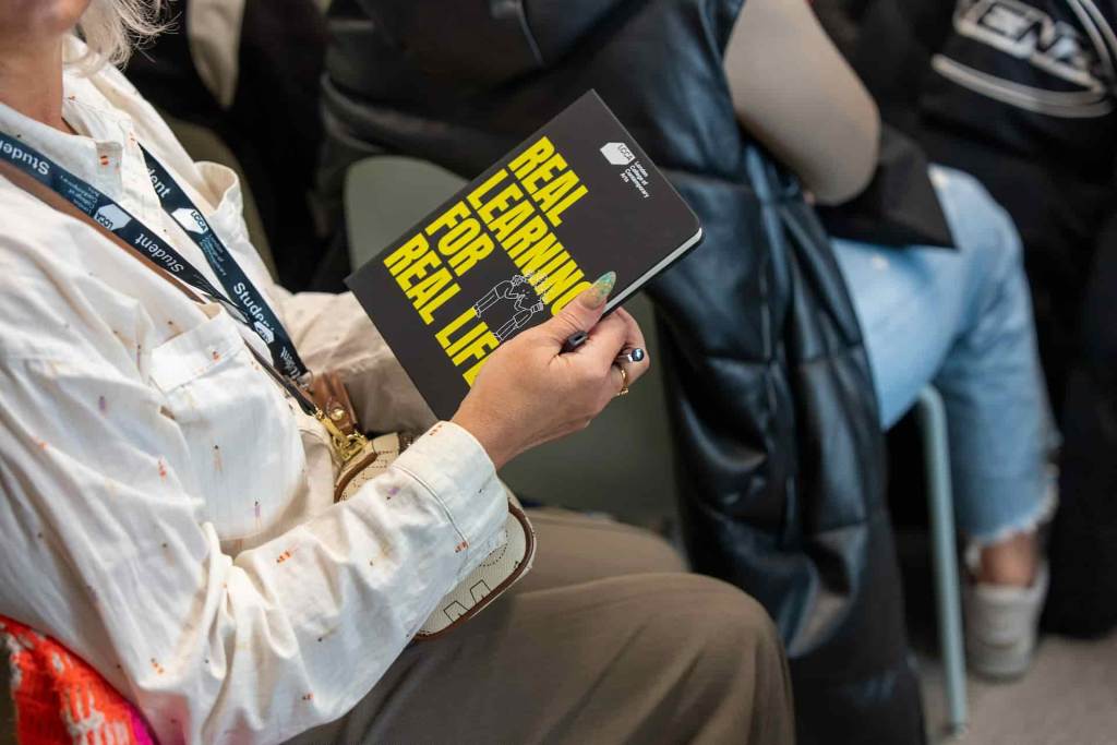 a person holding a LCCA notepad