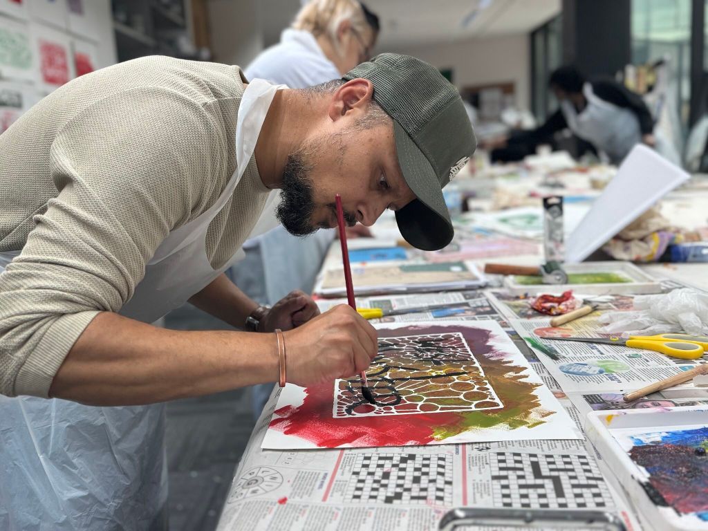Student painting in monoprinting workshop