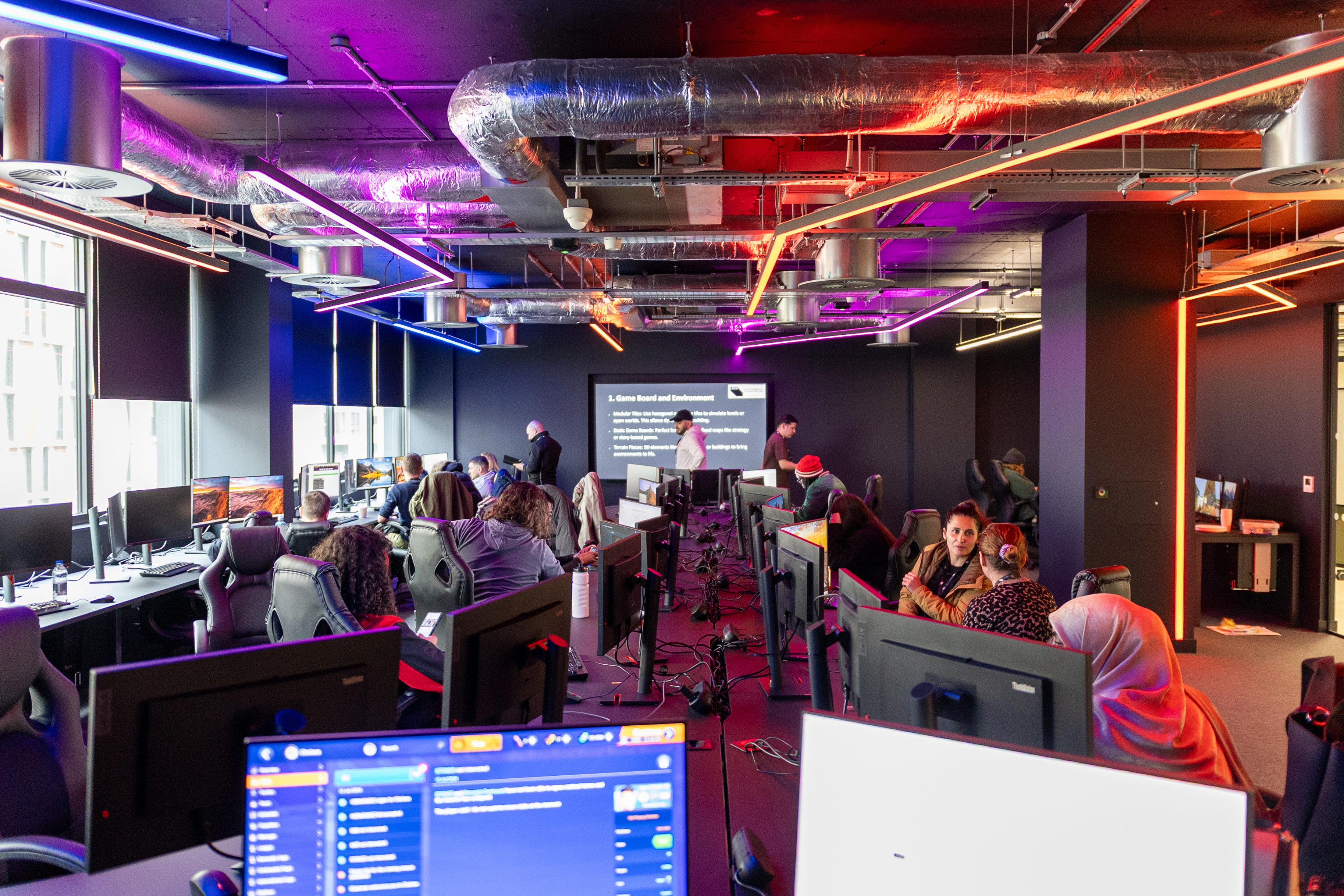 A group of students working the gaming lab
