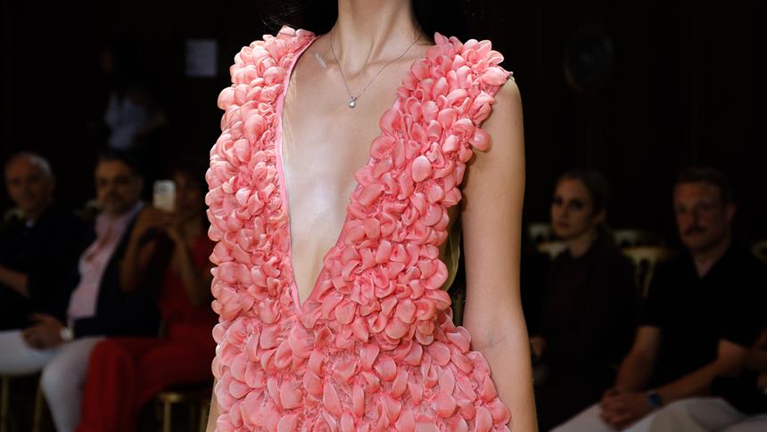 a zoomed in image of a women wearing a pink dress