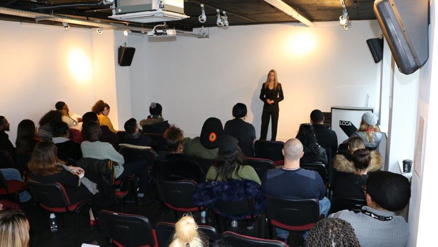 A room of LCCA students in an event with assistant director of Rosewood London