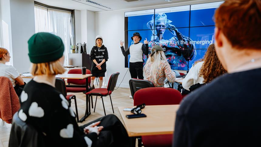 a group of people in a room looking at a presentation