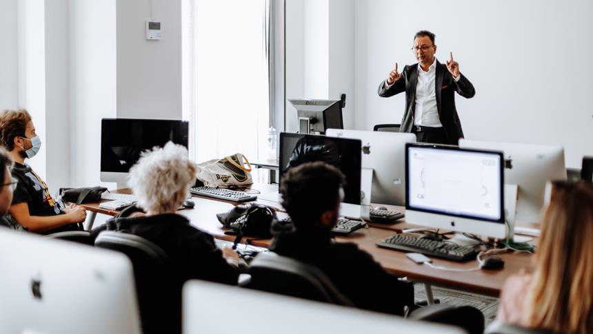 a man in black suit presenting