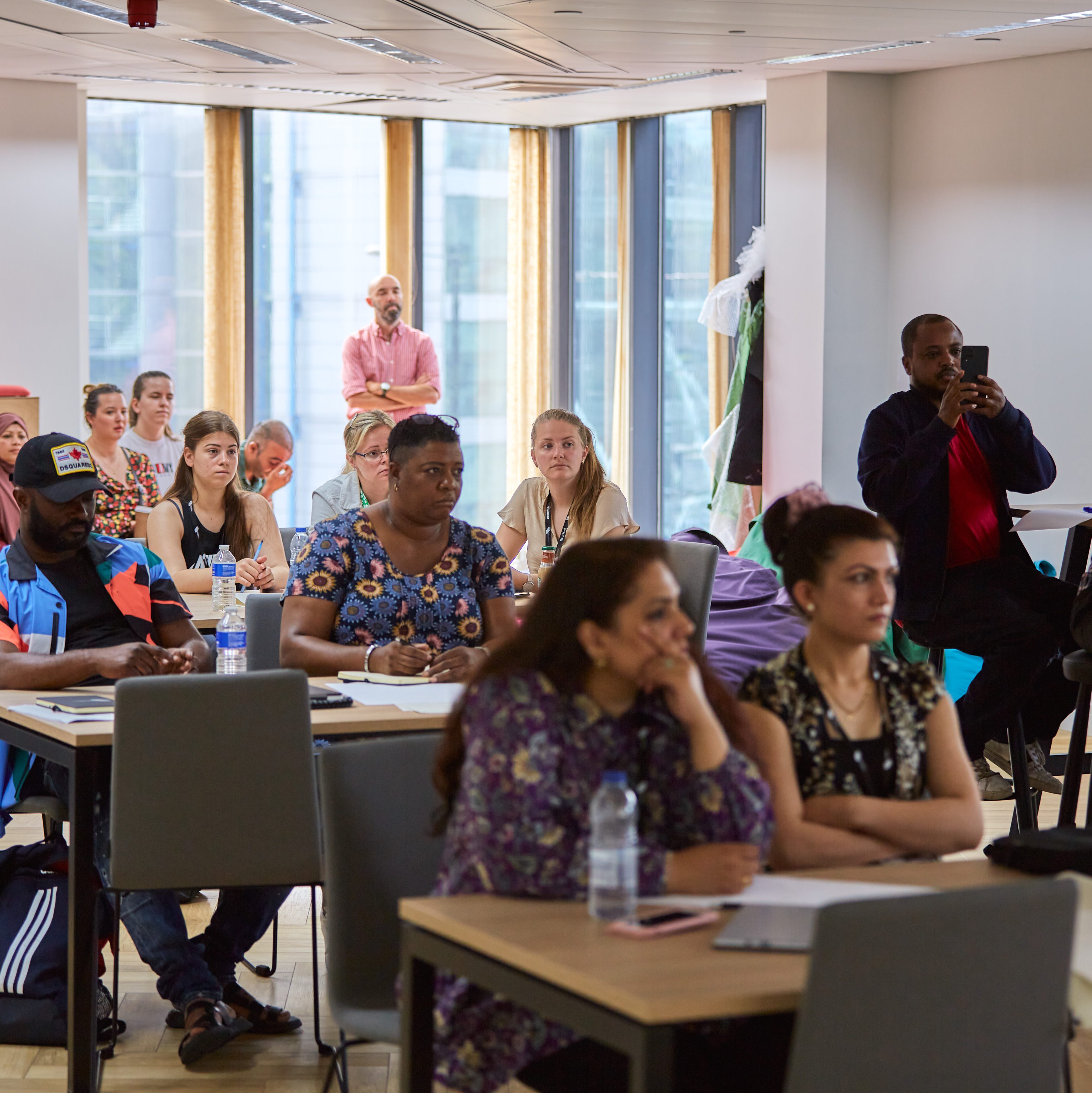 Students listening to a presentation in a group setting