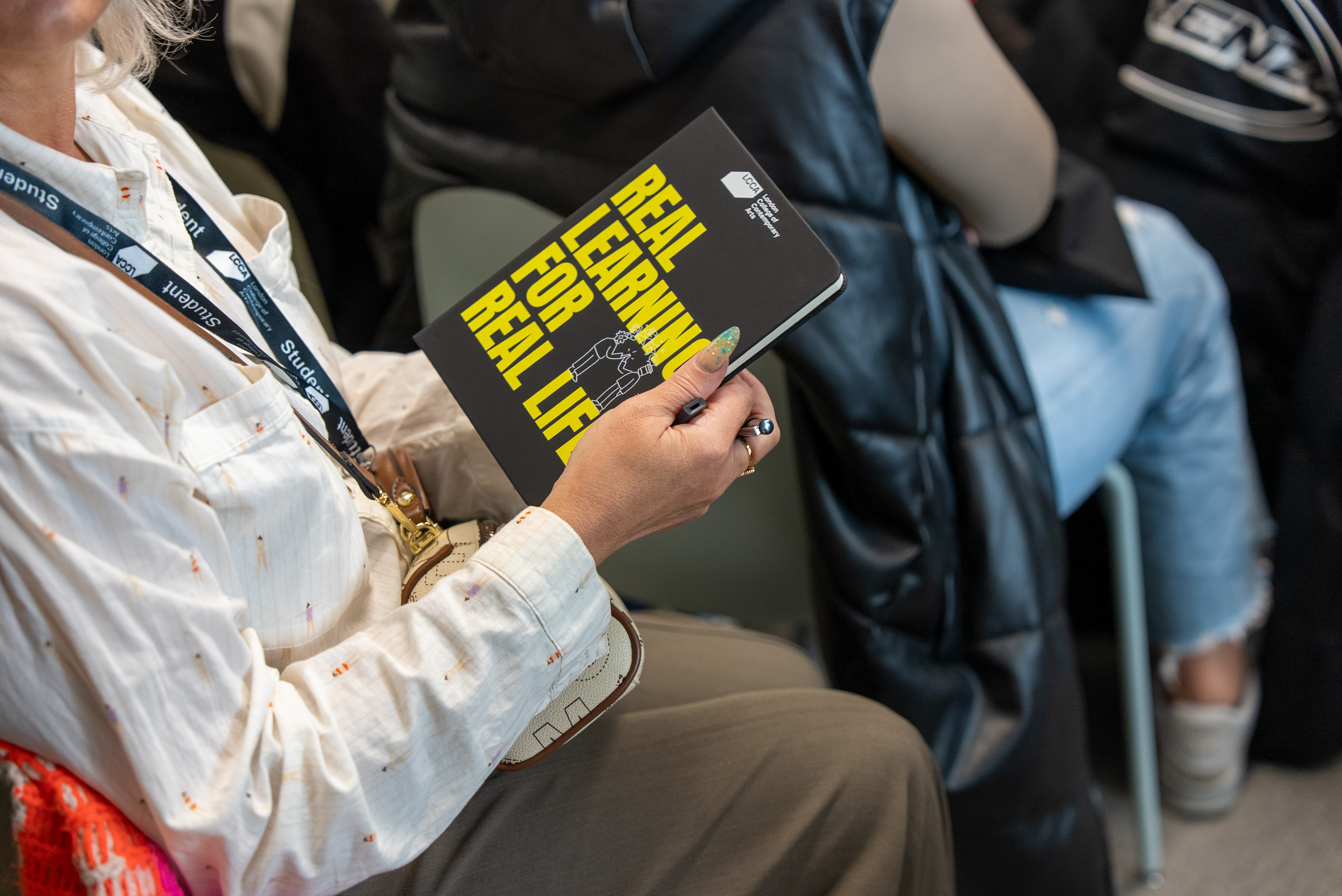 Person holding LCCA book