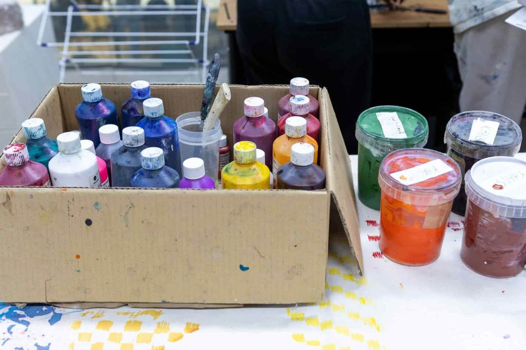 a box full of bottles of different paints