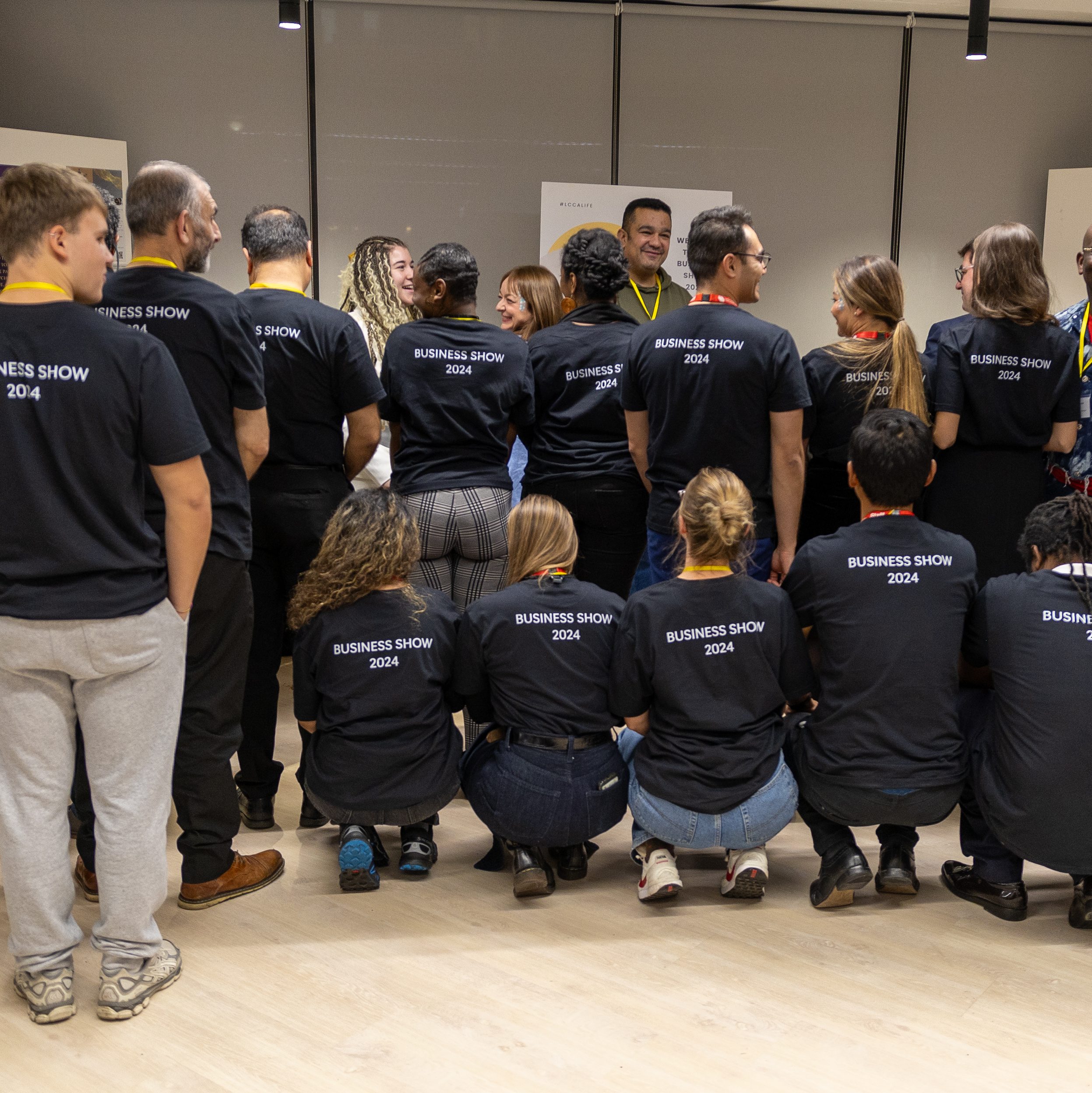 Students showing the 'Business Show' t-shirts at a student event