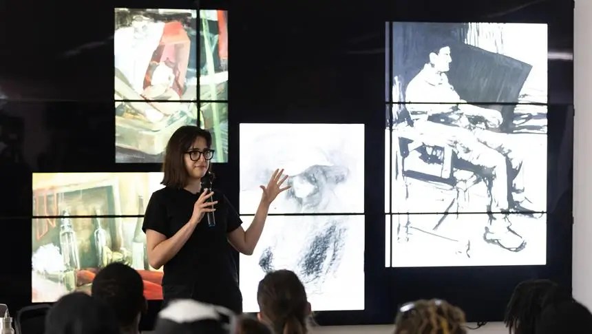 a girl presenting and talking with a mic