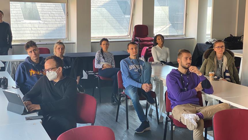 a group of people sitting in a classroom