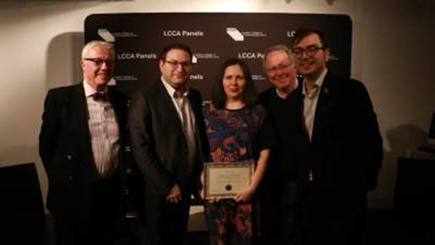 people standing with an award in their hand
