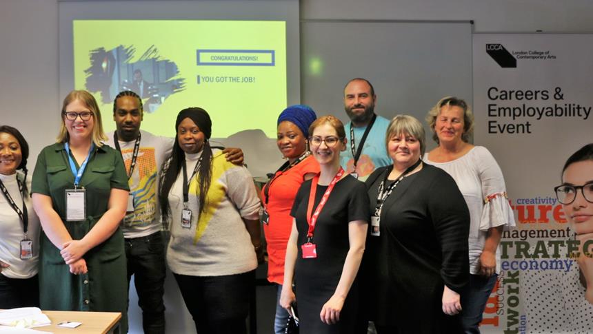 a group of people smiling at a careers event
