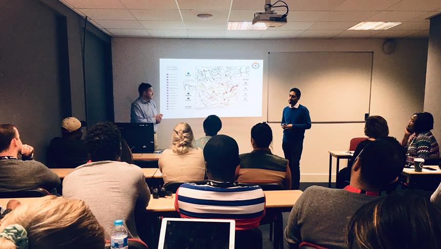 people in classroom looking at a presentation