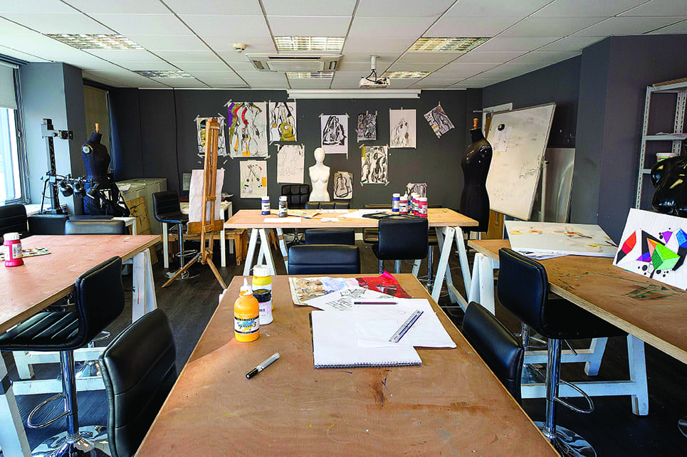 an art studio with students work on display