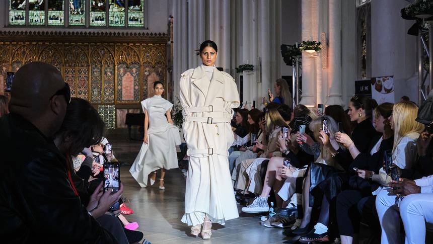 2 models walking at a runaway at a fashion show