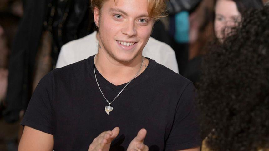 A person smiling and clapping