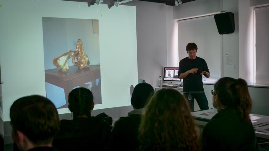 people in classroom looking at a presentation