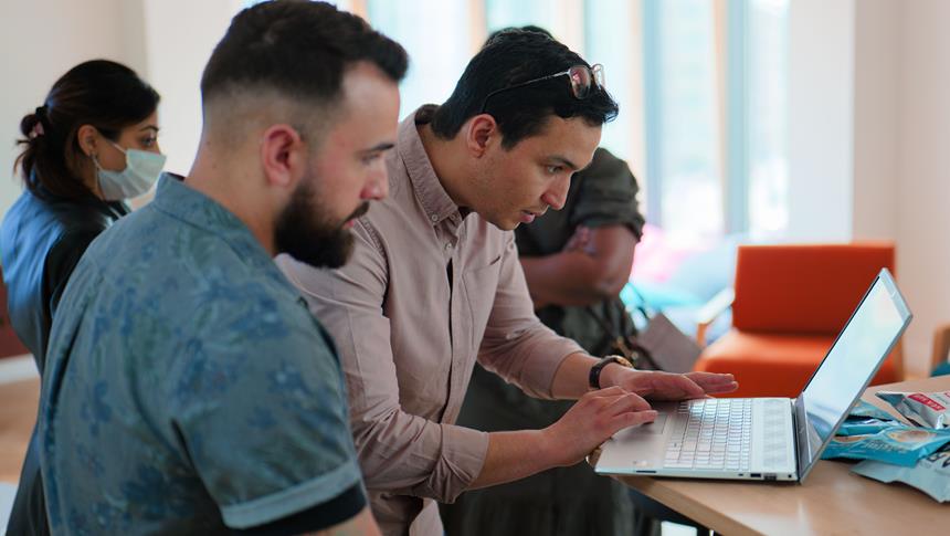 a person looking at a laptop