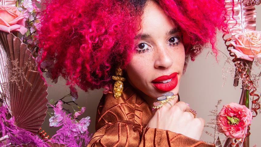 a women in red afro hair and red lipstick