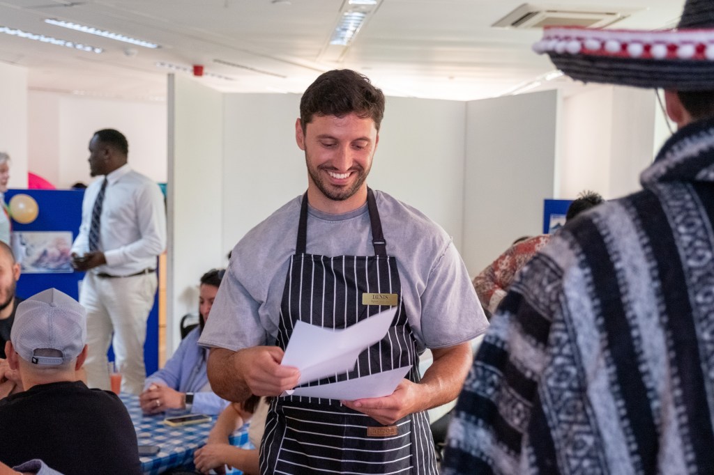 Student in apron smiling