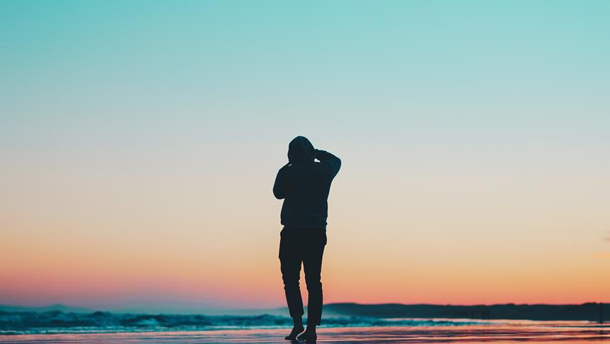 a person walking on the shore