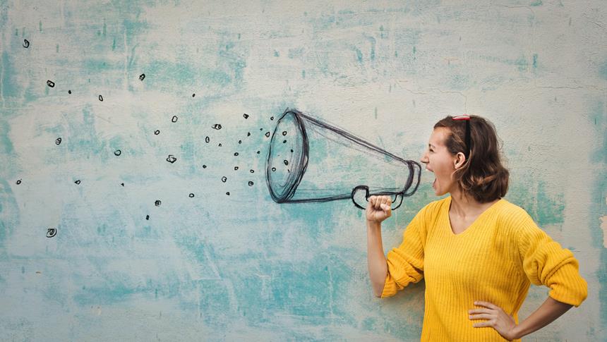 a person in a yellow jumper standing next to a doodlec